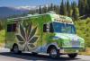 sundae driver strain logo of an ice cream truck with a cannabis leaf on the side driving through the countryside